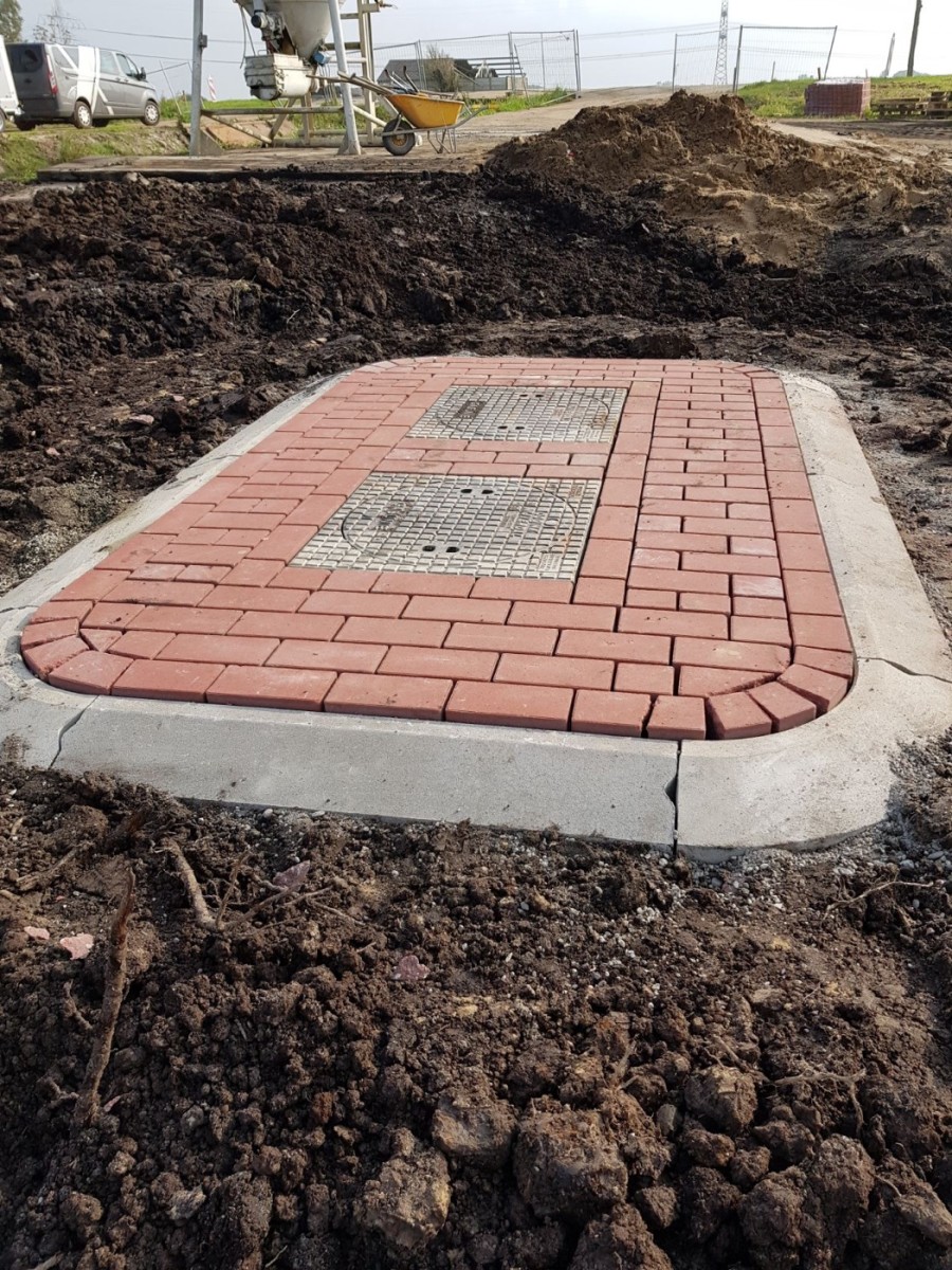 Technische putten en bestrating tijdens de aanleg van een gestabiliseerd terrein